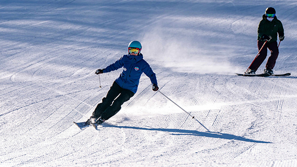 A Holiday Valley Snowsports instructor leads her lesson down a slope in a private lesson.